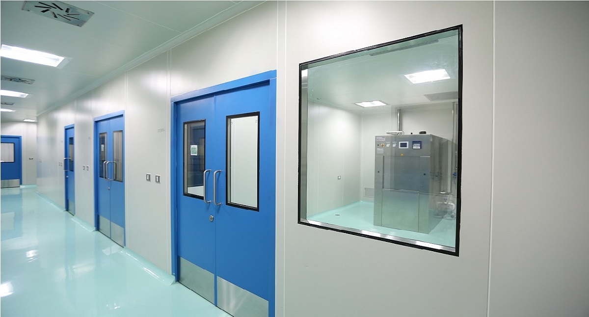 Pharmaceutical cleanroom corridor with blue doors and viewing windows