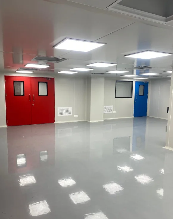 Completed cleanroom interior with red and blue doors, wall panels and smooth flooring